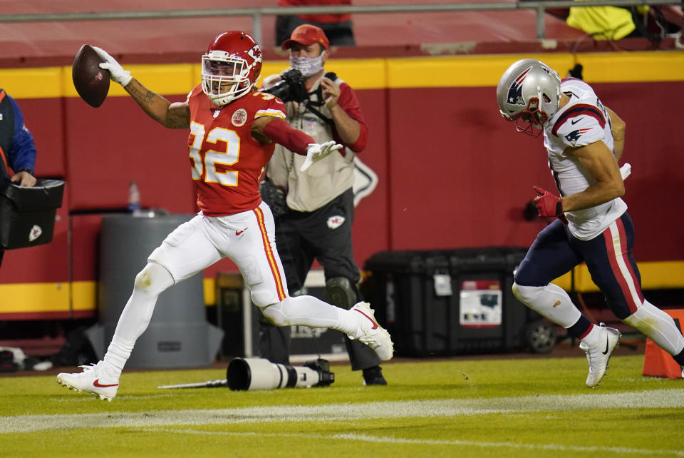 Kansas City Chiefs safety Tyrann Mathieu (32) runs from New England Patriots wide receiver Julian Edelman, right, while returning an interception 25-yards for a touchdown during the second half of an NFL football game, Monday, Oct. 5, 2020, in Kansas City. (AP Photo/Jeff Roberson)