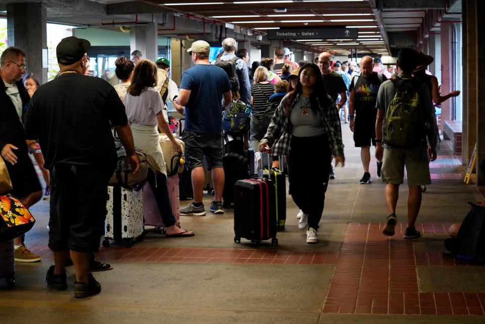 The line to get through TSA at Kahului Airport on Aug. 9, 2023, in Kahului, Maui. The line stretched from the security entrance to baggage claim. A large fire consumed the popular town of Lahaina overnight.