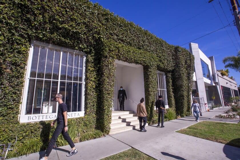 Los Angeles, CA - November 27: Shoppers pass by as a security guard waits for the store to open after a flash-mob entered the Bottega Veneta store Friday at 8445 Melrose Place and stole an unknown amount of items before using pepper spray on an employee and fleeing out the rear entrance at Melrose Place in Los Angeles, on Saturday, Nov. 27, 2021. A citywide tactical alert was issued and since lifted through the majority of the city following a ``smash-and-grab'' robbery at a high- end store in the Melrose area, according to the Los Angeles Police Department. KCAL9 reported about 8:20 p.m. Friday. KCAL9 also reported pepper spray was used during the robbery, but the LAPD could not be reached for details. This was among the latest in a series of so-called flash mob-style robberies in the Los Angeles area during the Thanksgiving holiday weekend. KCAL 9 reported that six smash-and-grab robberies took place in the Fairfax District, Beverly Grove and Hancock Park Friday. The LAPD defines a tactical alert as enabling all available officers to respond to a criminal incident if necessary. (Allen J. Schaben / Los Angeles Times)