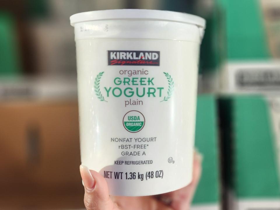 The writer holds a container of Kirkland Signature yogurt