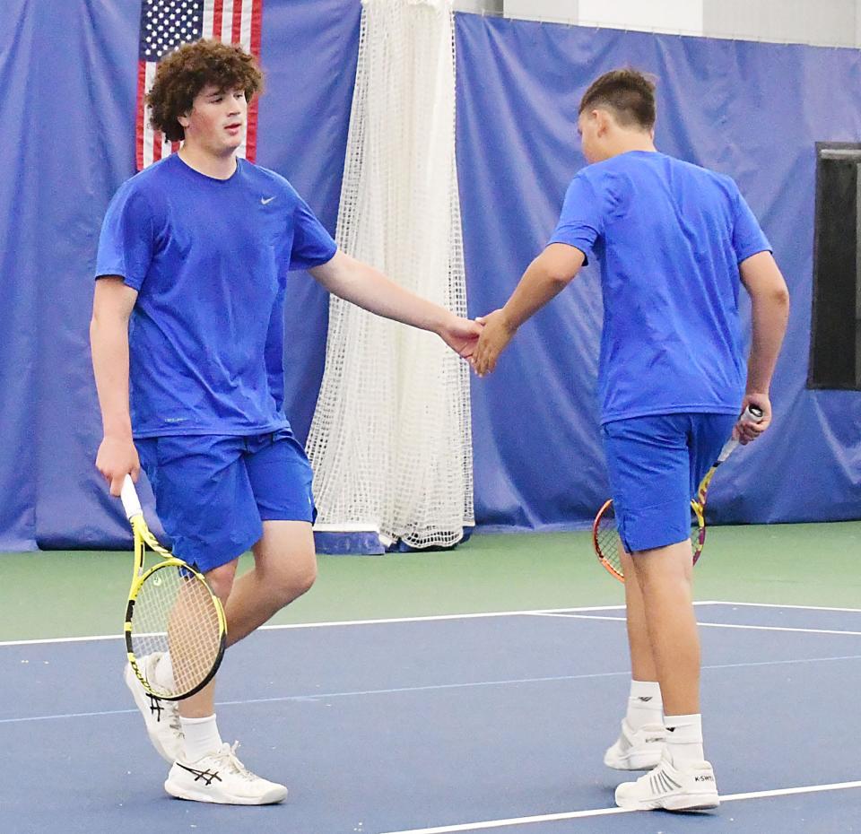 Aberdeen Central's AJ Prehn (left) and Mitchell Hofer celebrate after scoring a point in a first-flight singles match during the state 2023 Class AA high school boys tennis tournament. The two-day event concluded on Friday, May 19 at Sioux Falls.