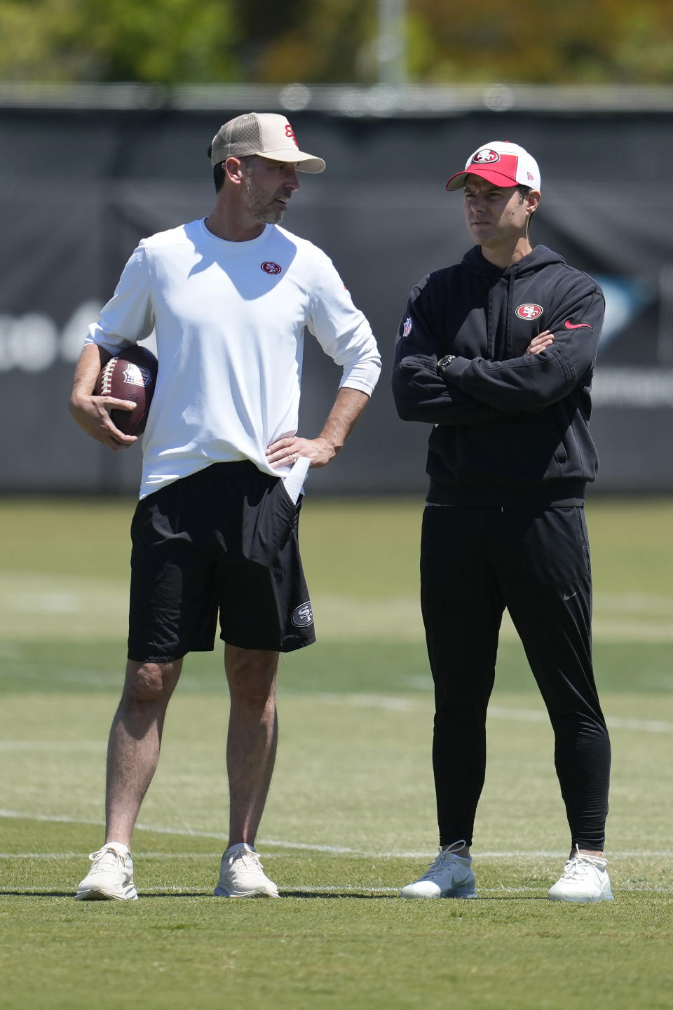 San Francisco 49ers head coach Kyle Shanahan, left, talks with assistant head coach Brandon Staley during the NFL football team's rookie minicamp in Santa Clara, Calif., Friday, May 10, 2024. (AP Photo/Jeff Chiu)