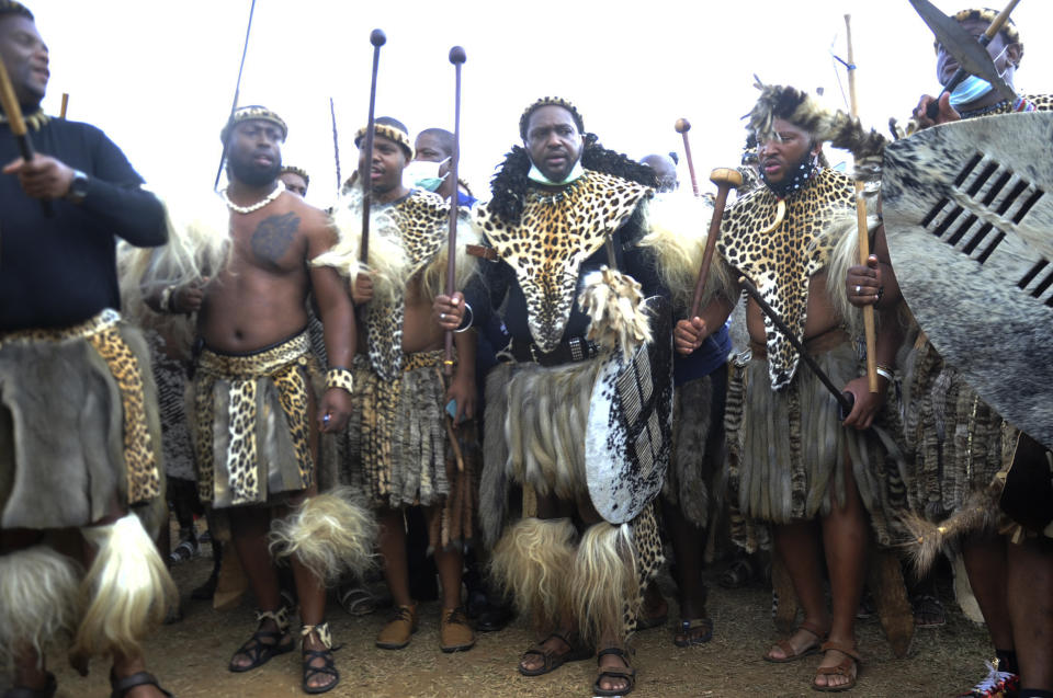 Prince Misuzulu Zulu, centre, flanked by fellow warriors in traditional dress at the KwaKhangelamankengane Royal Palace, during a ceremony, in Nongoma, Friday May 7, 2021. A new Zulu king in South Africa has been named amid scenes of chaos as other members of the royal family questioned Prince Misuzulu Zulu’s claim to the title. He was suddenly whisked away from the public announcement at a palace by bodyguards. The controversy over the next king has arisen after the death in March of King Goodwill Zwelithini, who had reigned since 1968. Zwelithini apparently named one of his six wives, Queen Mantfombi Shiyiwe Dlamini Zulu, as the “regent of the Zulu kingdom” in his will. But her death just over a week ago after holding the title for only a month has thrown the royal succession into turmoil. (AP Photo)