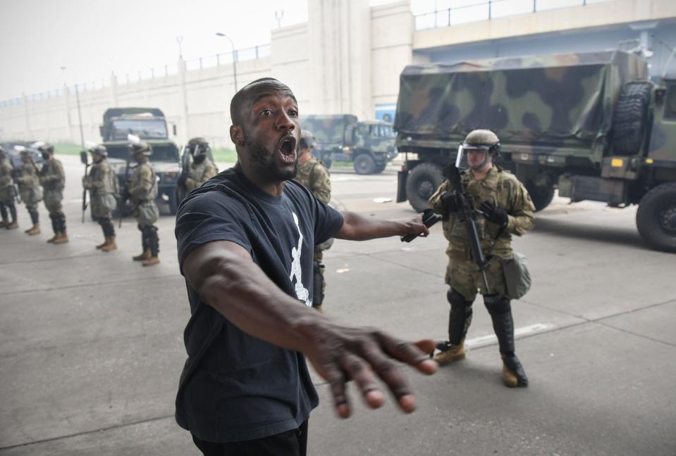 A protestor speaks near a line of National Guard troops near the former location of the Minneapolis Police Department’s Third Precinct building Friday, May 29, 2020, in Minneapolis.