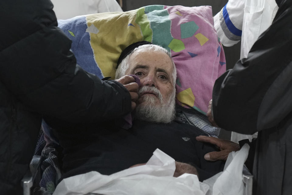 A mourner comforts the father of Tamir Avihai, 50, at his funeral in the West Bank Israeli settlement of Barkan, Tuesday, Nov. 15, 2022. A Palestinian killed three Israelis, including Avihai and wounded three others in an attack in a settlement in the occupied West Bank on Tuesday before he was shot and killed by Israeli security personnel, Israeli paramedics and Palestinian officials said. (AP Photo/ Tsafrir Abayov)