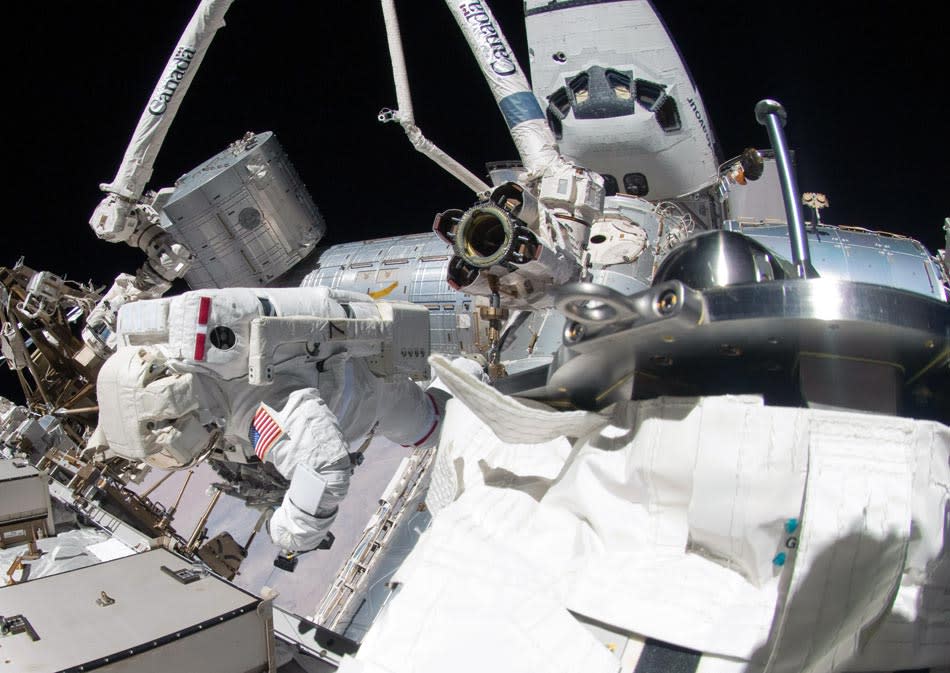 IN SPACE - MAY 26: In this handout provided by National Aeronautics and Space Administration (NASA), NASA astronaut Greg Chamitoff during the mission's fourth STS-134 spacewalk outside the International Space Station (ISS) May 26, 2011 in space. During the spacewalk, Chamitoff and fellow astronaut Michael Fincke stowed the 50-foot-long boom and added a power and data grapple fixture to make it the Enhanced International Space Station Boom Assembly, which extends the reach of the space station's robotic arm. The docked space shuttle Endeavour is visible at top right. After 20 years, 25 missions and more than 115 million miles in space, NASA space shuttle Endeavour is on its final flight to the International Space Station before being retired and donated to the California Science Center in Los Angeles. Capt. Mark E. Kelly, U.S. Rep. Gabrielle Giffords' (D-AZ) husband, will lead mission STS-134 as it delivers the Express Logistics Carrier-3 (ELC-3) and the Alpha Magnetic Spectrometer (AMS-2) to the International Space Station. (Photo by NASA via Getty Images)