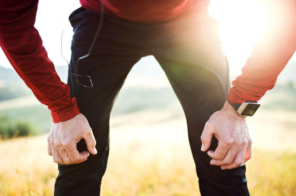 Unrecognizable senior man resting after exercise outdoors in nature in the morning.