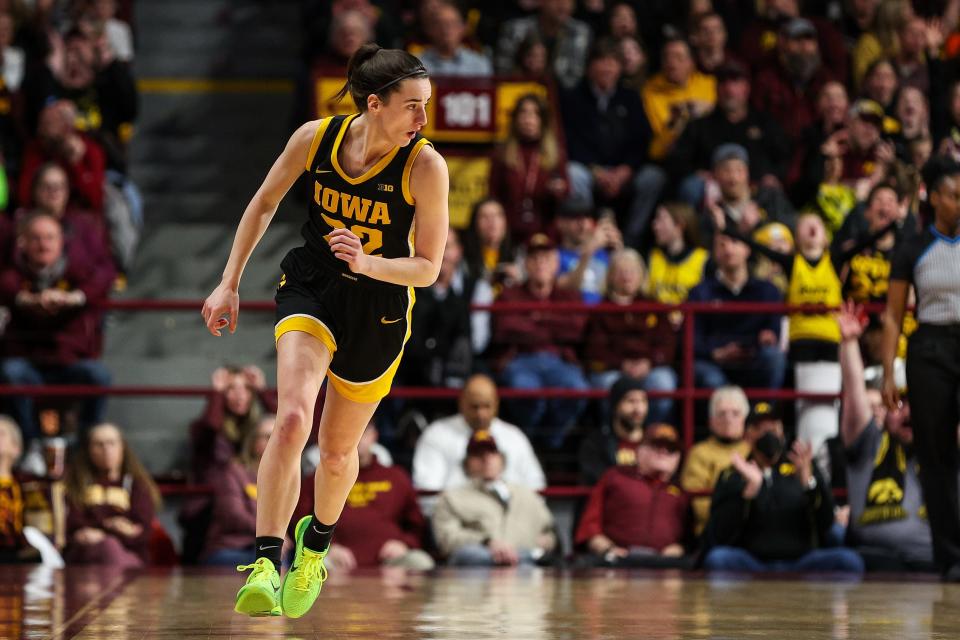 Iowa guard Caitlin Clark jogs up the court after hitting a 3-pointer against Minnesota.