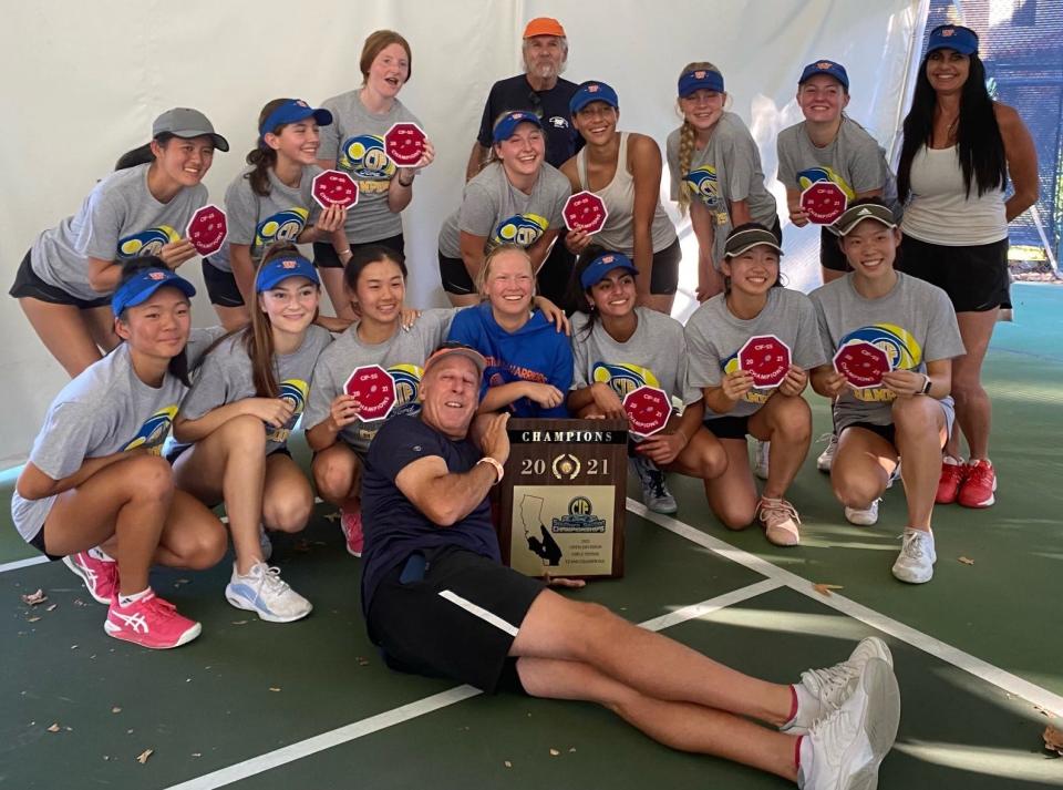 The Westlake High girls tennis team poses with the championship plaque after winning the CIF-Southern Section Open Division.