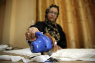 An Afghan woman tailor works with a sewing machine in the Afghan Women Business Hub in Kabul, Afghanistan, Tuesday, July 2, 2024. Half of Afghanistan's population now finds itself locked out of the freedom to work at a time when the country's economy is worse than ever, with few jobs available to women in the country.(AP Photo/Siddiqullah Alizai)