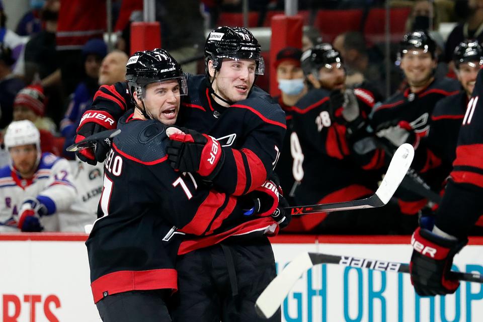 Carolina Hurricanes' Jesper Fast, right, celebrates his goal with teammate Tony DeAngelo (77) during the second period of an NHL hockey game against the New York Rangers in Raleigh, N.C., Friday, Jan. 21, 2022.