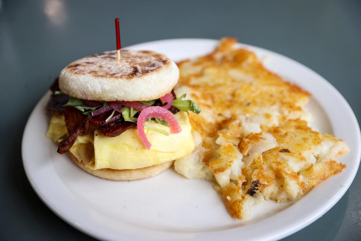 All Good Things' breakfast sandwich is served with eggs, bacon, pickled onions, arugula and garlic cream cheese with crispy homestyle potatoes.