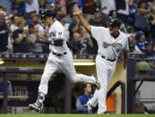 Jul 21, 2018; Milwaukee, WI, USA; Milwaukee Brewers left fielder Christian Yelich (22) is greeted by third base coach Ed Sedar after hitting a solo home run in the sixth inning during the game against the Los Angeles Dodgers at Miller Park. Mandatory Credit: Benny Sieu-USA TODAY Sports