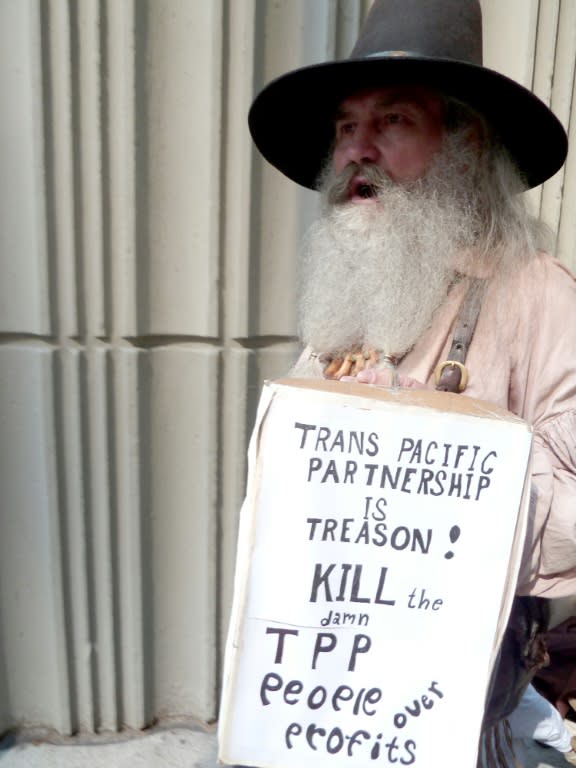 A man protests outside the Westin Peachtree Plaza Hotel in Atlanta, Georgia, where trade ministers from the US, Japan and 10 other Pacific Rim countries are trying to negotiate a final agreement on the TPP trade agreement, on October 1, 2015