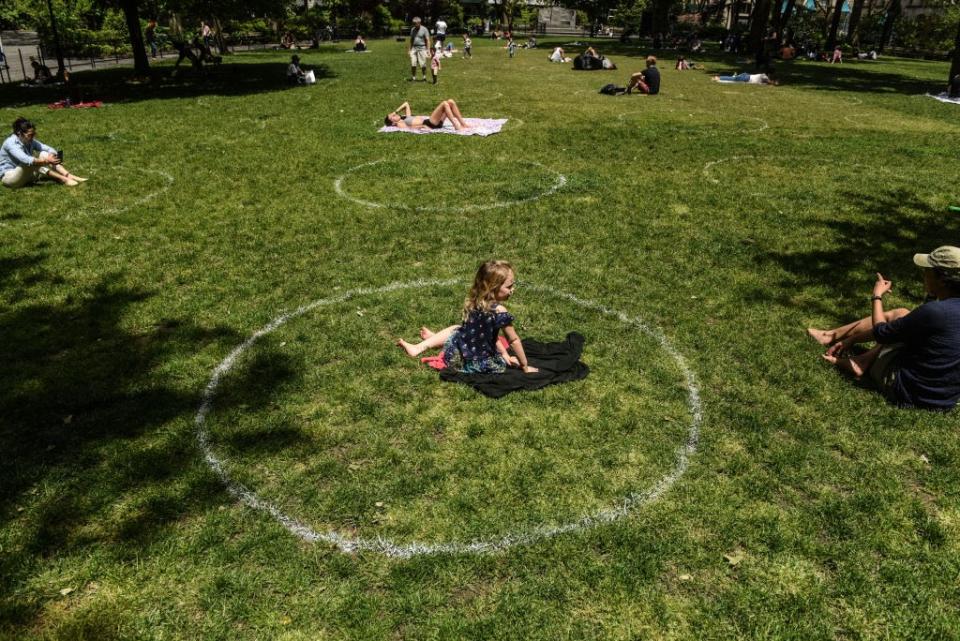 May 22: A young girl sits inside a painted circle for social distancing in Madison Square Park in New York City. (Getty Images)