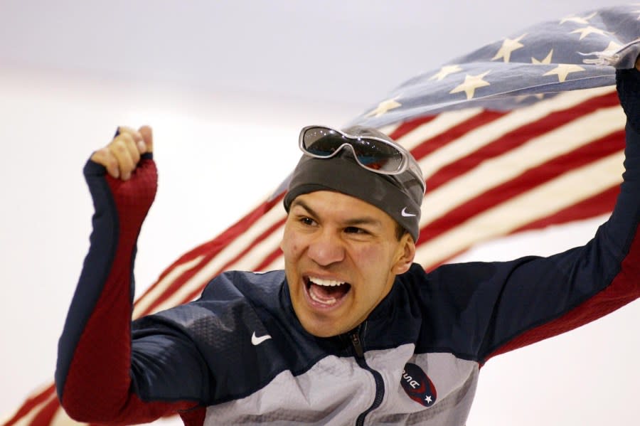 Derek Parra celebrates after skating to a gold medal in the men’s 15,000-meter speed skating event. (Photo by Tim De Waele/Getty Images)