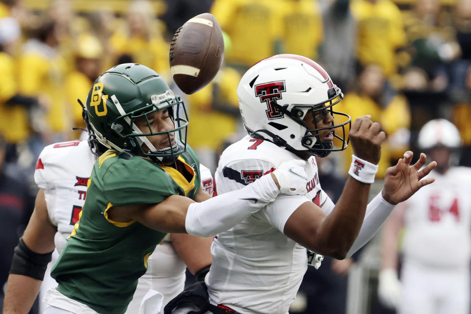 Baylor cornerback Raleigh Texada, left, forces aTexas Tech quarterback Donovan Smith fumble in the first half of an NCAA college football game, Saturday, Nov. 27, 2021, in Waco, Texas. (Rod Aydelotte/Waco Tribune-Herald via AP)