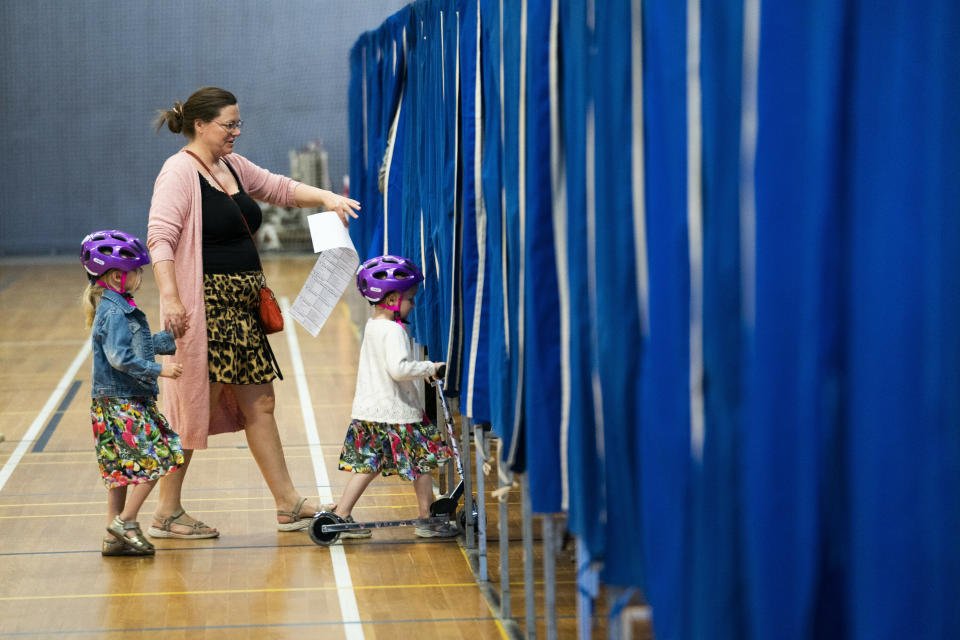 A woman and two children enter the voting booth in Copenhagen during the Danish Parliamentary Election 2019 ON Wednesday 5 June 2019. (Liselotte Sabroe/Ritzau Scanpix via AP)