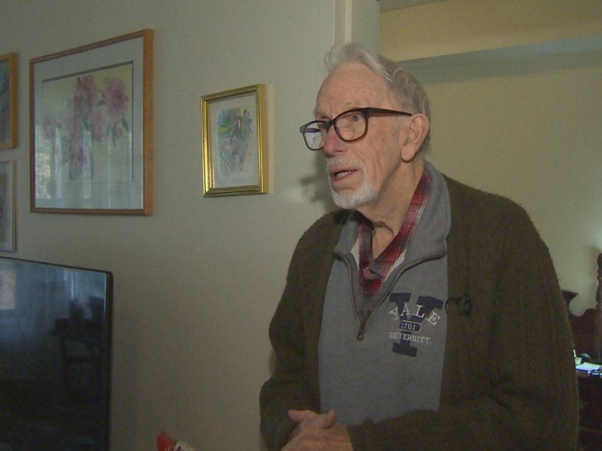 David George Bryant stands in his apartment. The 90-year-old is getting rid of most of his belongings to move into a smaller, rented room which is less than half the size of his current Drumlin Hills apartment in Bridgewater, N.S.  (Brian MacKay/CBC - image credit)