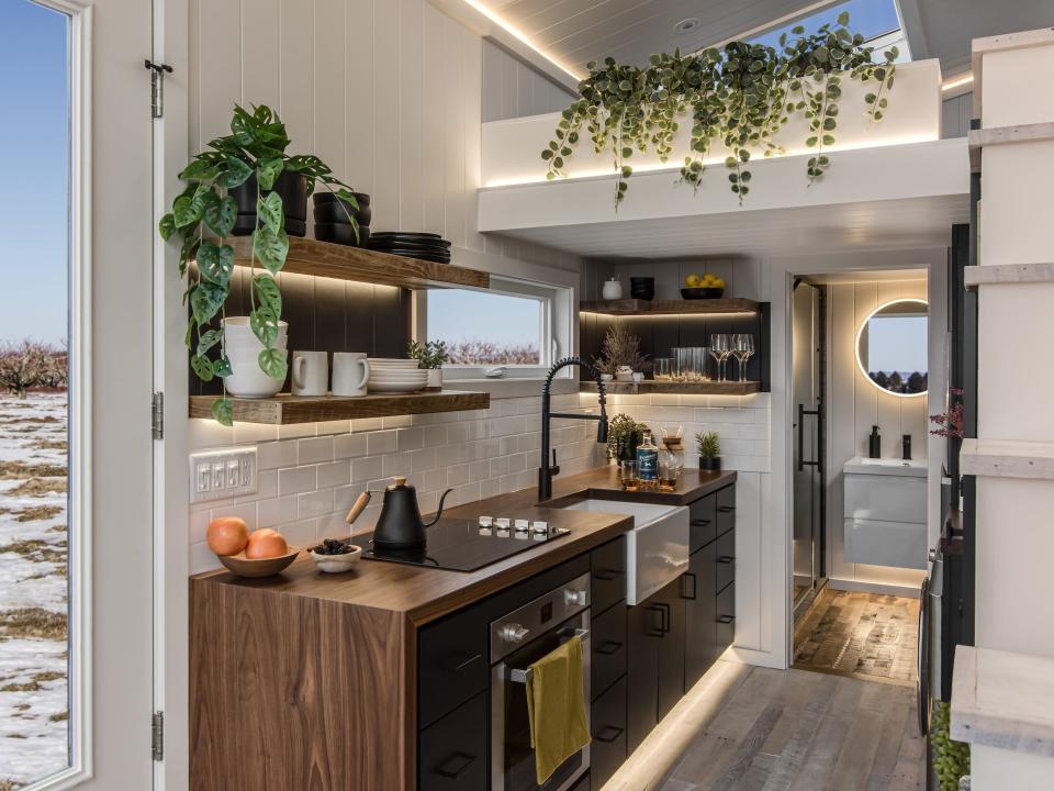 the kitchen space in front of the bathroom next to the staircase