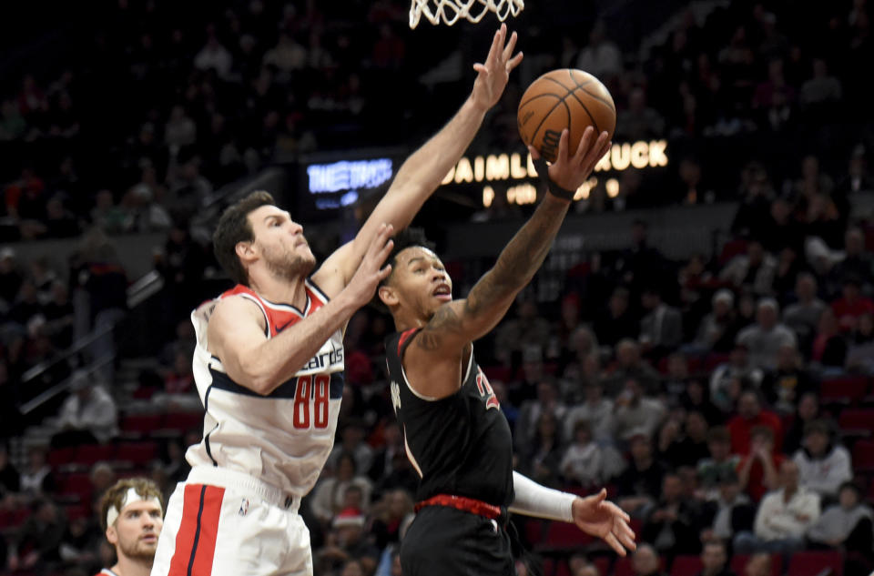 Portland Trail Blazers guard Anfernee Simons, right, drives to the basket against Washington Wizards forward Danilo Gallinari (88) during the first half of an NBA basketball game in Portland, Ore., Thursday, Dec. 21, 2023. (AP Photo/Steve Dykes)