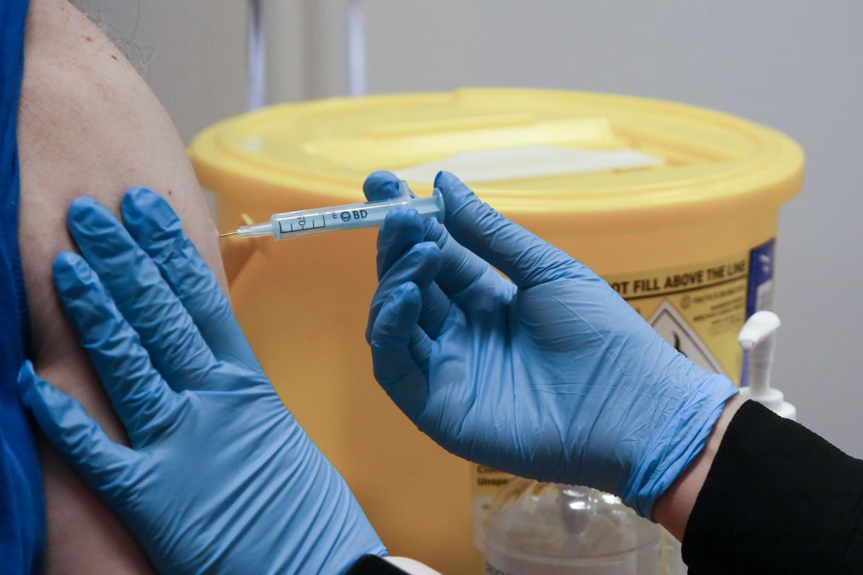 London, UK. 13th Dec, 2021. A health worker administers the Moderna Covid-19 booster vaccine to a man at a vaccination centre. Prime Minister Boris Johnson announced that all adults over the age of 18 in England will be offered a Covid-19 booster jab by the end of this year. (Credit Image: © Dinendra Haria/SOPA Images via ZUMA Press Wire)