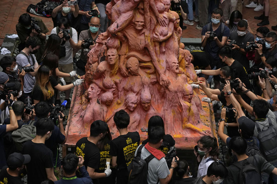 University students clean the "Pillar of Shame" statue, a memorial for those killed in the 1989 Tiananmen crackdown, at the University of Hong Kong, Friday, June 4, 2021. Police arrested an organizer of Hong Kong's annual candlelight vigil remembering the deadly Tiananmen Square crackdown and warned people not to attend the banned event Friday as authorities mute China's last pro-democracy voices. (AP Photo/Kin Cheung)