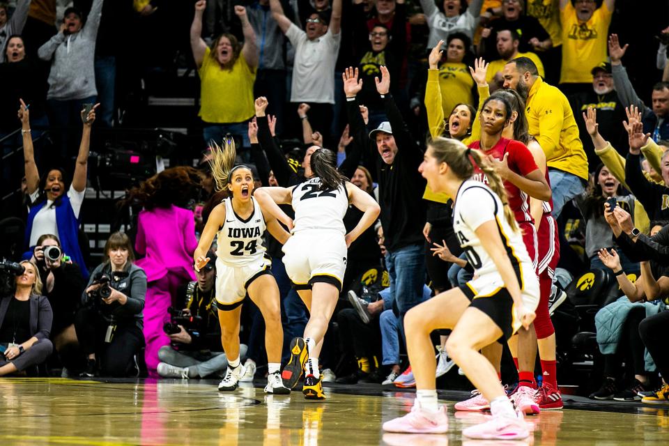 Iowa guard Caitlin Clark (22) celebrates with Iowa guard Gabbie Marshall (24) after making the game-winning 3-point basket during a NCAA Big Ten Conference women's basketball game against Indiana, Sunday, Feb. 26, 2023, at Carver-Hawkeye Arena in Iowa City, Iowa.