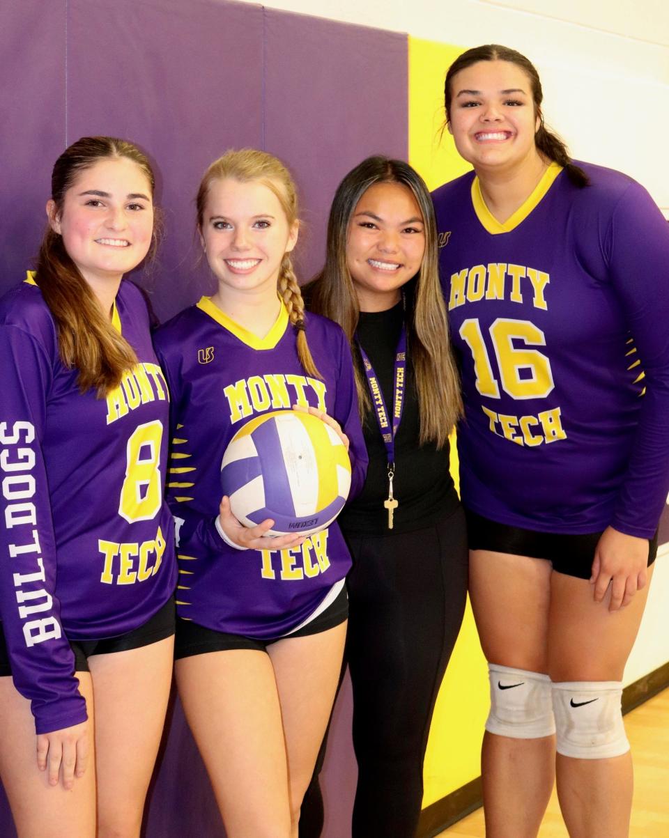 Monty Tech captains and coach left to right: Bailey Tetreault (No. 8), Deanna Smith (holding volleyball), Coach Sandy Duong, and Jayda DeCarlo (No. 16).