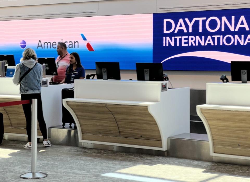 An air traveler checks in her suitcase for a departing flight at Daytona Beach International Airport on Thursday, March 30, 2023.