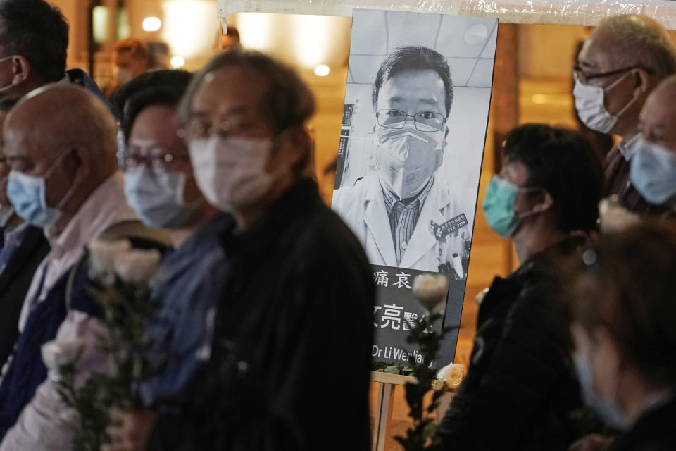 FILE - In this Feb. 7, 2020 file photo, people wearing masks attend a vigil for Chinese doctor Li Wenliang, in Hong Kong. The outpouring of grief and rage sparked by Li's death was an unusual - and for the Chinese Communist Party, unsettling - display in China's tightly monitored civic space. (AP Photo/Kin Cheung, File)