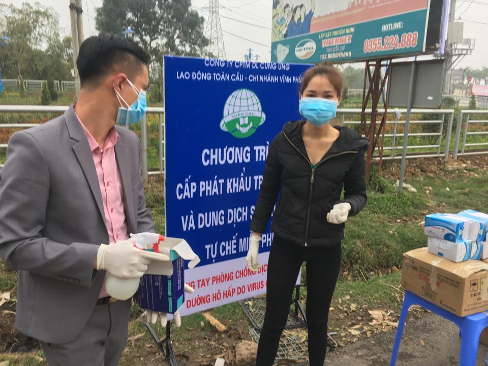 Health officials stand in front of a warning sign about the COVID-19 disease at a checkpoint before entering the Son Loi commune in Vinh Phuc province, Vietnam on Thursday, Feb. 13, 2020. 0fficial media reported that the Son Loi commune with 10,000 residents northwest of the capital Hanoi was put in lockdown due to a cluster of cases there. Vietnam has confirmed 16 cases of the disease. (AP Photo/Yves Dam Van)