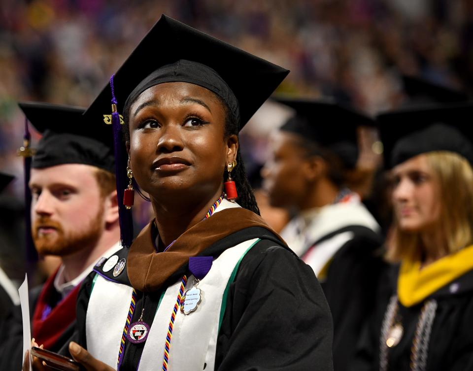 Obiamaka Igwenagu of Auburn looks up at the stands as families cheer during the Holy Cross commencement.