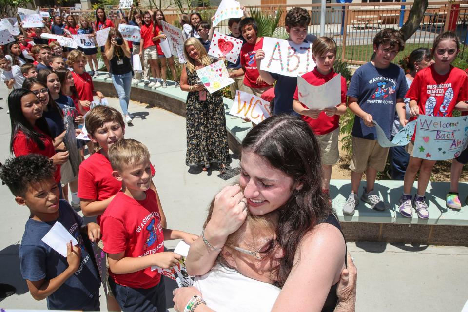 American Idol finalist and former student Abi Carter hugs her former kindergarten teacher Pamela Marks while visiting George Washington Charter School in Palm Desert, Calif., May 14, 2024.