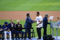 Former Los Angeles Dodgers pitcher Fernando Valenzuela, in suit, shakes the hand of Sen. Alex Padilla, D-Calif., during his jersey retirement ceremony before a baseball game between the Dodgers and Colorado Rockies, Friday, Aug. 11, 2023, in Los Angeles. (AP Photo/Ryan Sun)