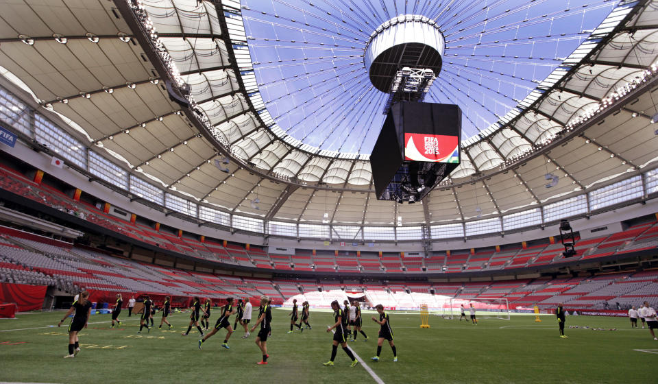 FILE - U.S. players run drills during a practice for the Women's World Cup soccer final under the open roof of BC Place in Vancouver, British Columbia, Canada, Saturday, July 4, 2015. There are 23 venues bidding to host soccer matches at the 2026 World Cup in the United States, Mexico and Canada.(AP Photo/Elaine Thompson)