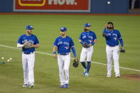 Toronto Blue Jays players Travis Shaw, left to right, Joe Panik, Bo Bichette and Vladimir Guerrero Jr. walk back to the dugout prior to an intrasquad baseball game, Friday, July 10, 2020 in Toronto. (Carlos Osorio/The Canadian Press via AP)