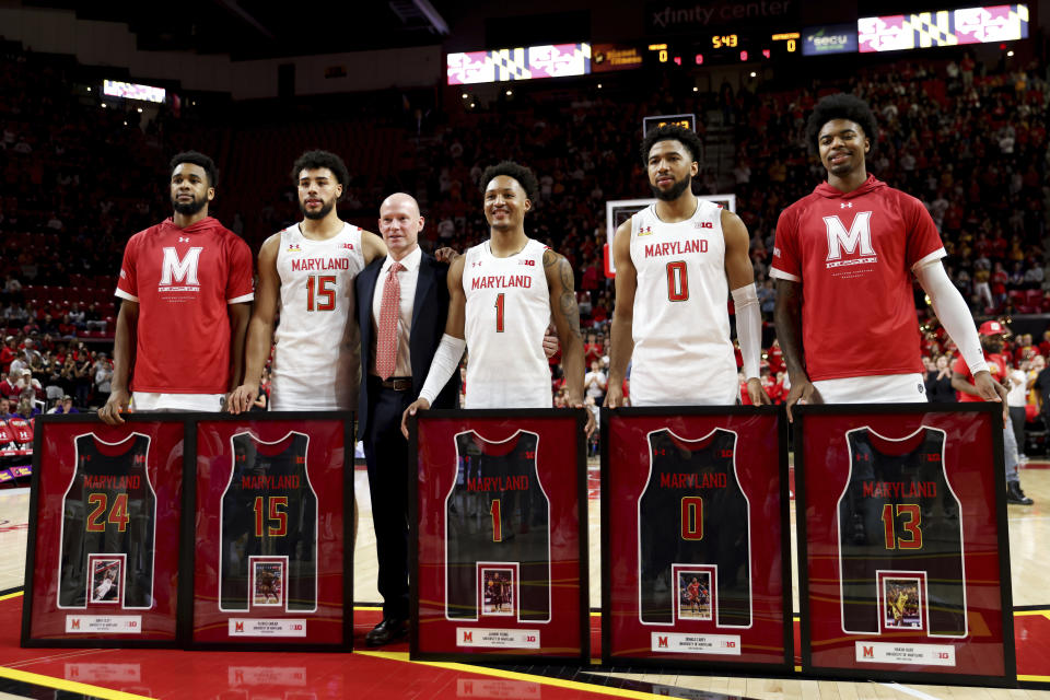 Maryland forward Donta Scott, forward Patrick Emilien, head coach Kevin Willard, guard Jahmir Young, guard Don Carey and guard Hakim Hart pose for photos during the Senior Day celebration before an NCAA college basketball game against Northwestern, Sunday, Feb. 26, 2023, in College Park, Md. Maryland won 75-59. (AP Photo/Julia Nikhinson)