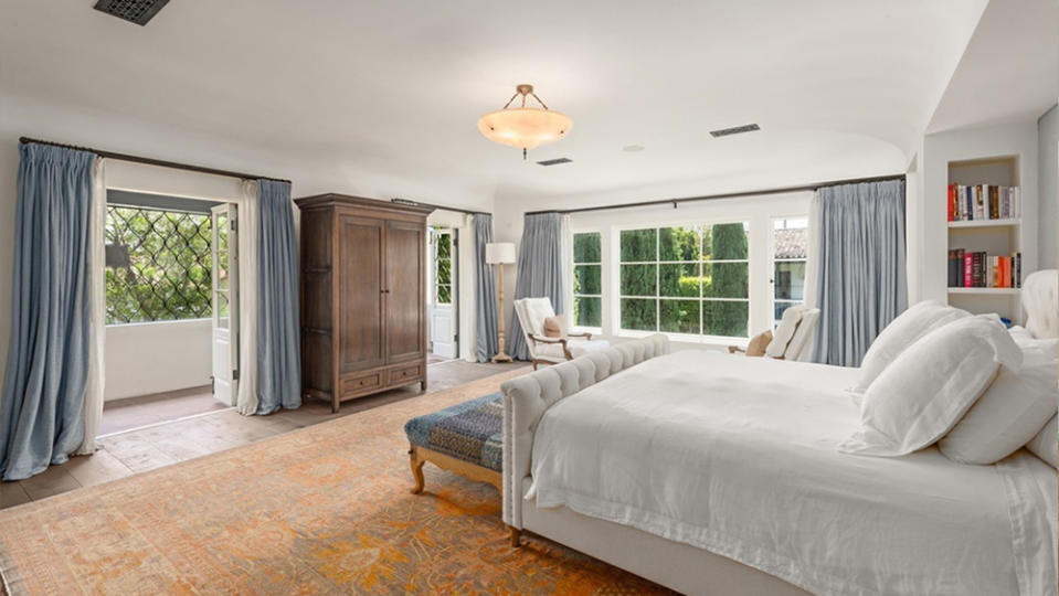 The spacious master bedroom with large windows and an outdoor balcony. - Credit: Redfin