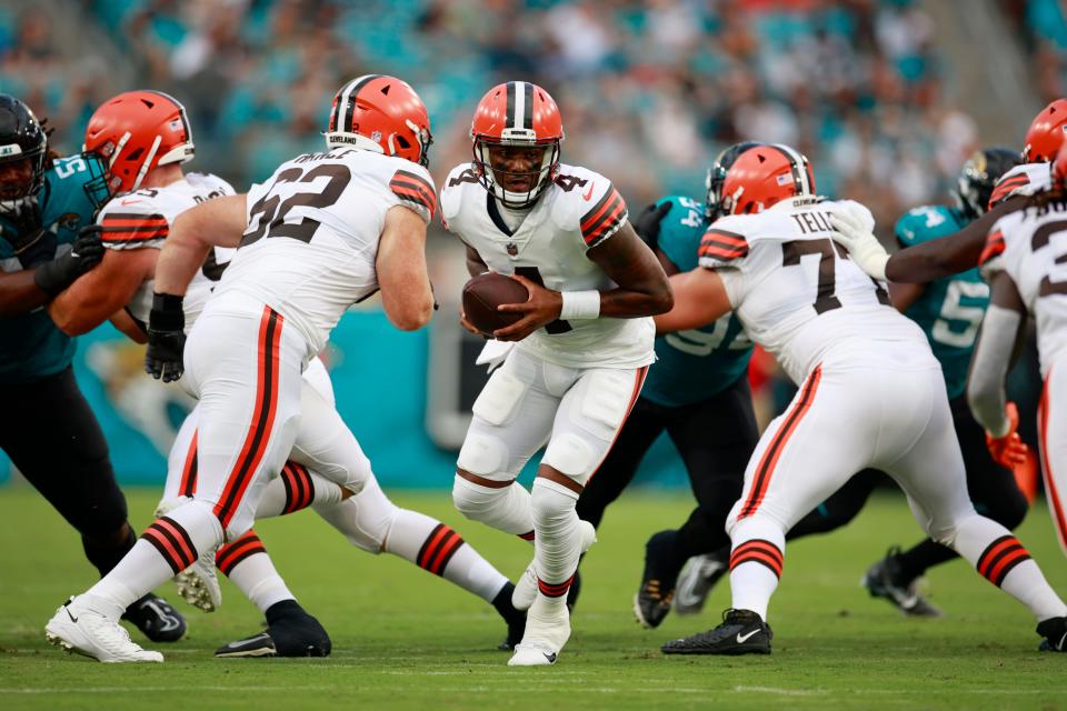 Cleveland Browns quarterback Deshaun Watson #4 hands off during the first quarter of a preseason NFL game Friday, Aug. 12, 2022 at TIAA Bank Field in Jacksonville. The Cleveland Browns defeated the Jacksonville Jaguars 24-13. [Corey Perrine/Florida Times-Union]