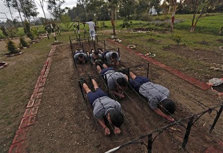 Trainees take part in an exercise during a training session at the training academy of the Security and Intelligence Services (India) firm, at Dehradun in the Himalayan Indian state of Uttarakhand February 28, 2014. REUTERS/Adnan Abidi