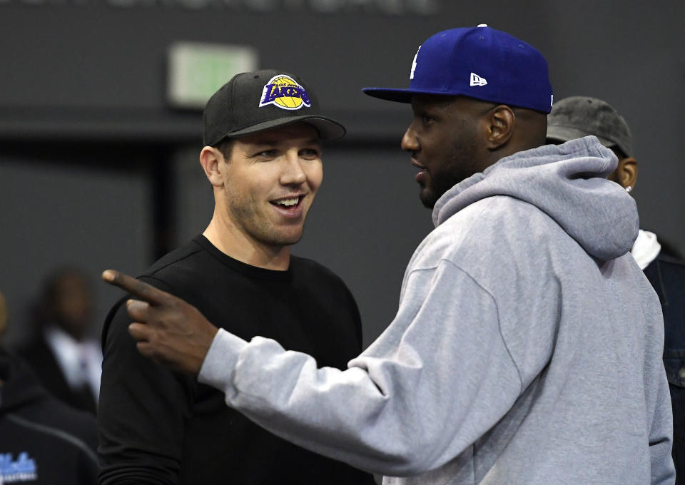 Lamar Odom talks with Lakers coach Luke Walton in March. (AP)