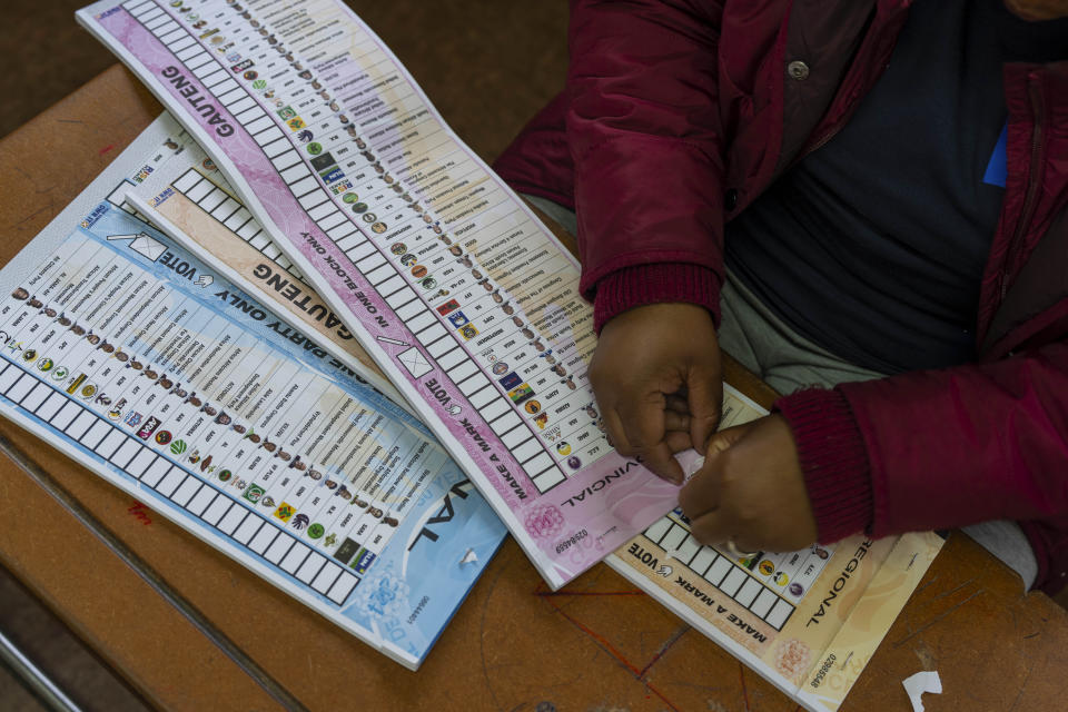 An election official prepares the ballots Wednesday May 29, 2024, for the general elections in Soweto, South Africa. South Africans are voting in an election seen as their country's most important in 30 years, and one that could put them in unknown territory in the short history of their democracy, the three-decade dominance of the African National Congress party being the target of a new generation of discontent in a country of 62 million people — half of whom are estimated to be living in poverty. (AP Photo/Jerome Delay)