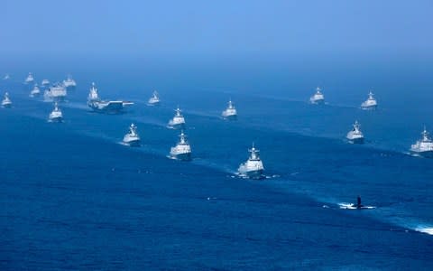 The Liaoning aircraft carrier is accompanied by navy frigates and submarines conducting an exercises in the South China Sea - Credit: Xinhua via AP