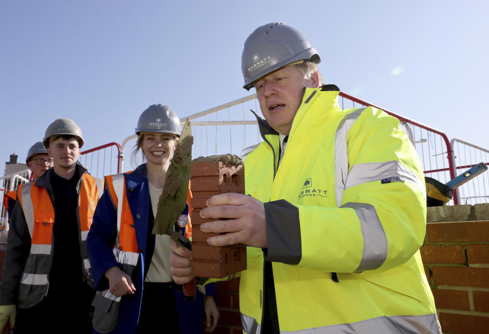 Britain's Prime Minister Boris Johnson poses for a photo during a visit to Barratt Homes development site Great Oldbury, in Gloucestershire, England, Monday, April 19, 2021, to launch the government's 95 percent mortgage guarantee scheme. (Jonathan Buckmaster, Pool Photo via AP)