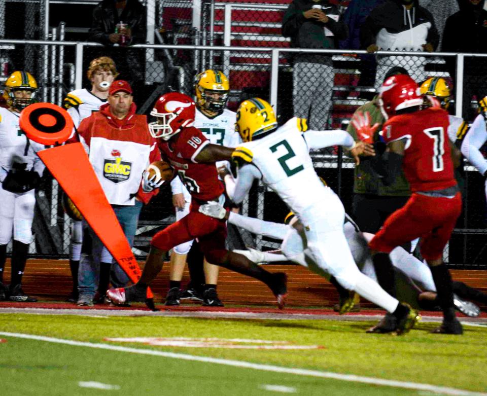 Jaleel Engleman, No 16, of Princeton runs to the endzone with Sycamore’s No. 2 Justin Williams right beside him during the playoff game between Princeton and Sycamore high schools, Nov. 5, 2021, at Princeton.