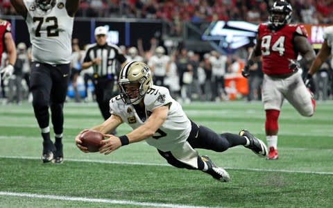 New Orleans Saints quarterback Drew Brees (9) dives for a rushing touchdown in the fourth quarter against the Atlanta Falcons - Credit: (Jason Getz/USA Today)