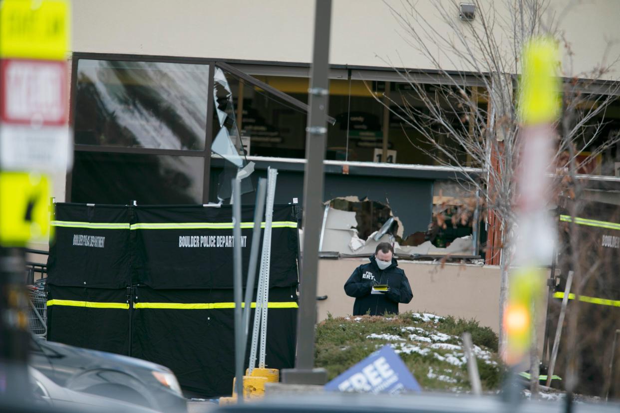 Police work on the scene outside of a King Soopers grocery store where authorities say multiple people were killed in a shooting, Monday, March 22, 2021, in Boulder, Colo.
