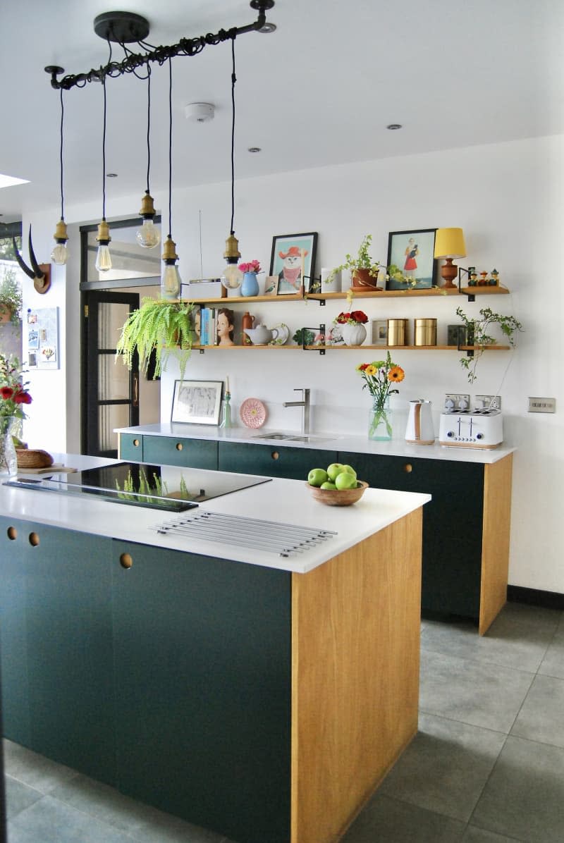 Kitchen with white counter tops black cabinets and wooden accents.