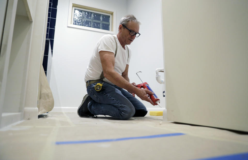 Contractor Mike Hewitt works on a project at a home in Austin, Texas, Tuesday, Oct. 30, 2018. Hewitt, a self-employed home remodeling contractor covered by Obamacare who is planning to renew, fell off a roof a few years ago and he says he was lucky that he was covered by the ACA because it allowed him to get treatment for a shattered heel and torn arm muscles. Sign-up season for the Affordable Care Act’s subsidized health insurance starts Thursday, and for a change the outlook for the program is stable.  (AP Photo/Eric Gay)